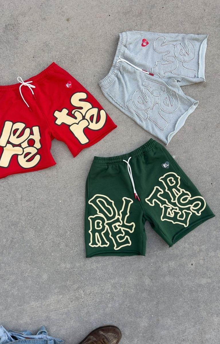 Close-up of hand-frayed distressed hem on green Red Letters sweat shorts