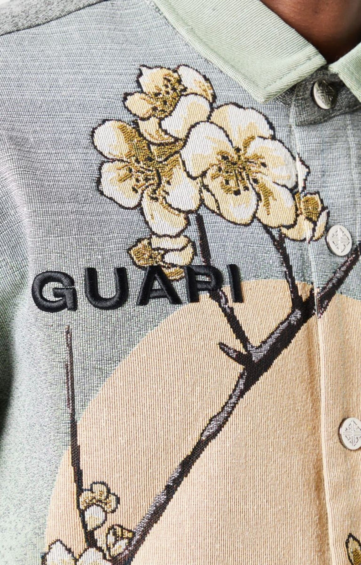 Guapi men’s tapestry floral button-down shirt in pastel green with cherry blossom design, modeled against white background