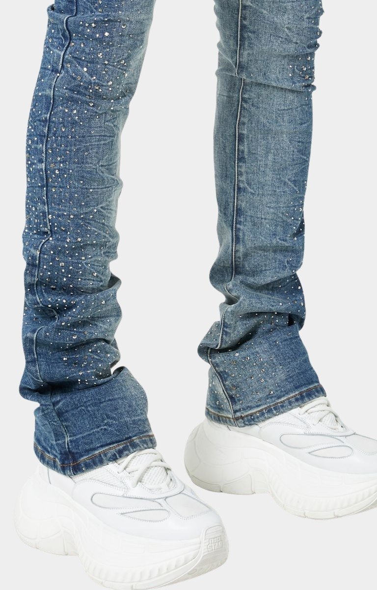 Model wearing GUAPI Acid Blue Starry Sky skinny stacked jeans with luxury streetwear styling.