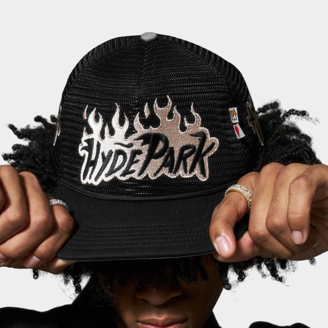 Close-up of model wearing Hyde Park Nothing But Net logo detail on trucker hat