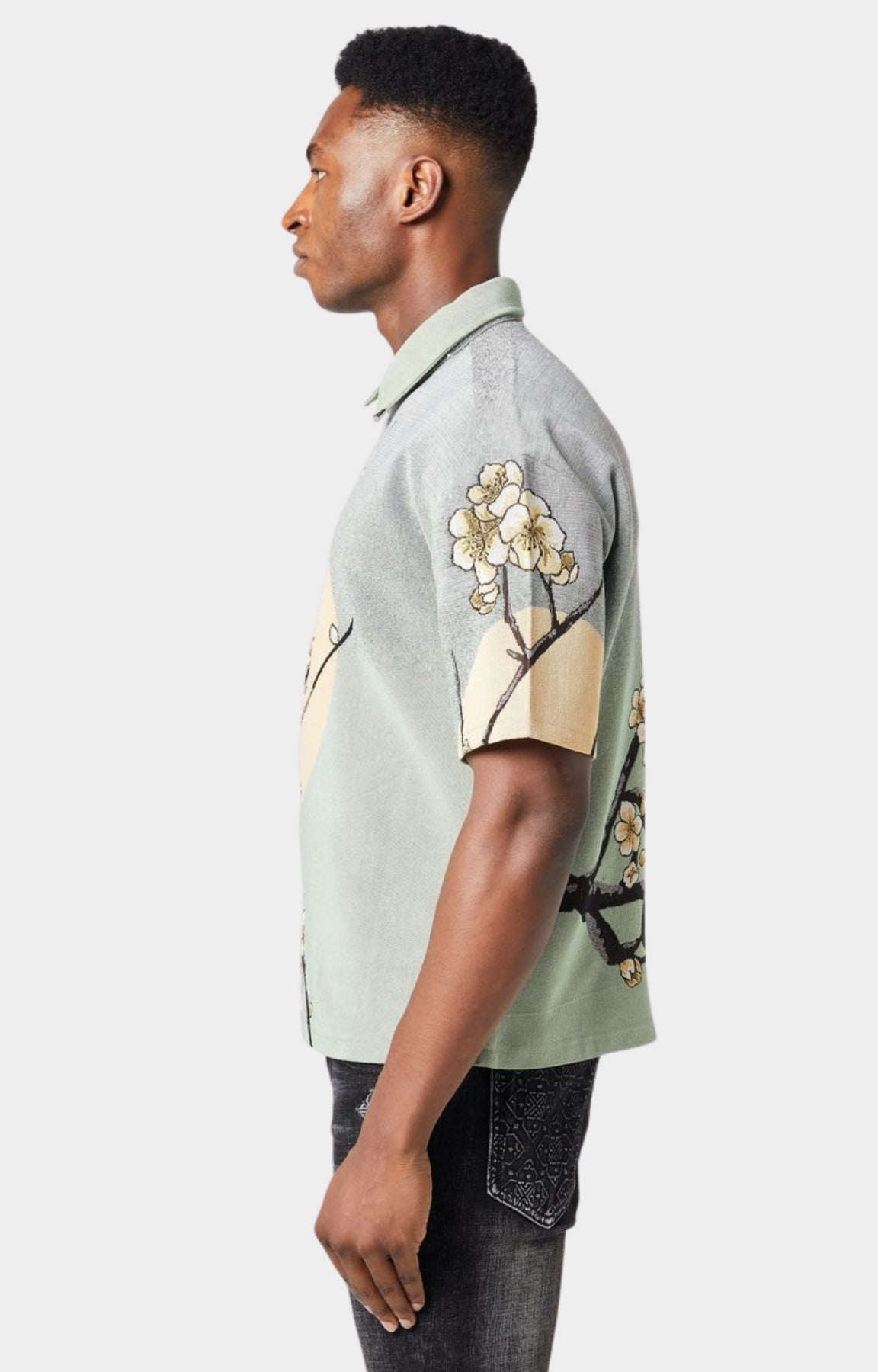 Guapi men’s tapestry floral button-down shirt in pastel green with cherry blossom design, modeled against white background