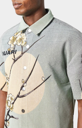 Guapi men’s tapestry floral button-down shirt in pastel green with cherry blossom design, modeled against white background