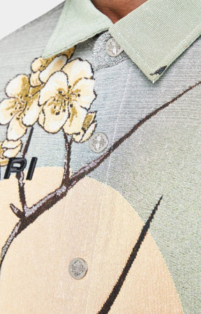 Guapi men’s tapestry floral button-down shirt in pastel green with cherry blossom design, modeled against white background