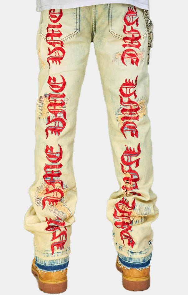 Back view embroidered stacked jeans with red graphics.