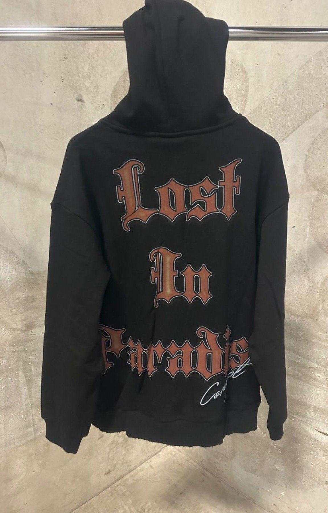 Concept Carousel Hoodie Black – Back View with Lost in Paradise Text.