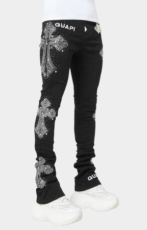 GUAPI designer distressed black jeans with silver chain accessory.