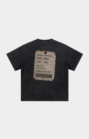 Drip Trap dark gray washed t-shirt shown from the back, featuring a distressed paper label graphic with text and a barcode.