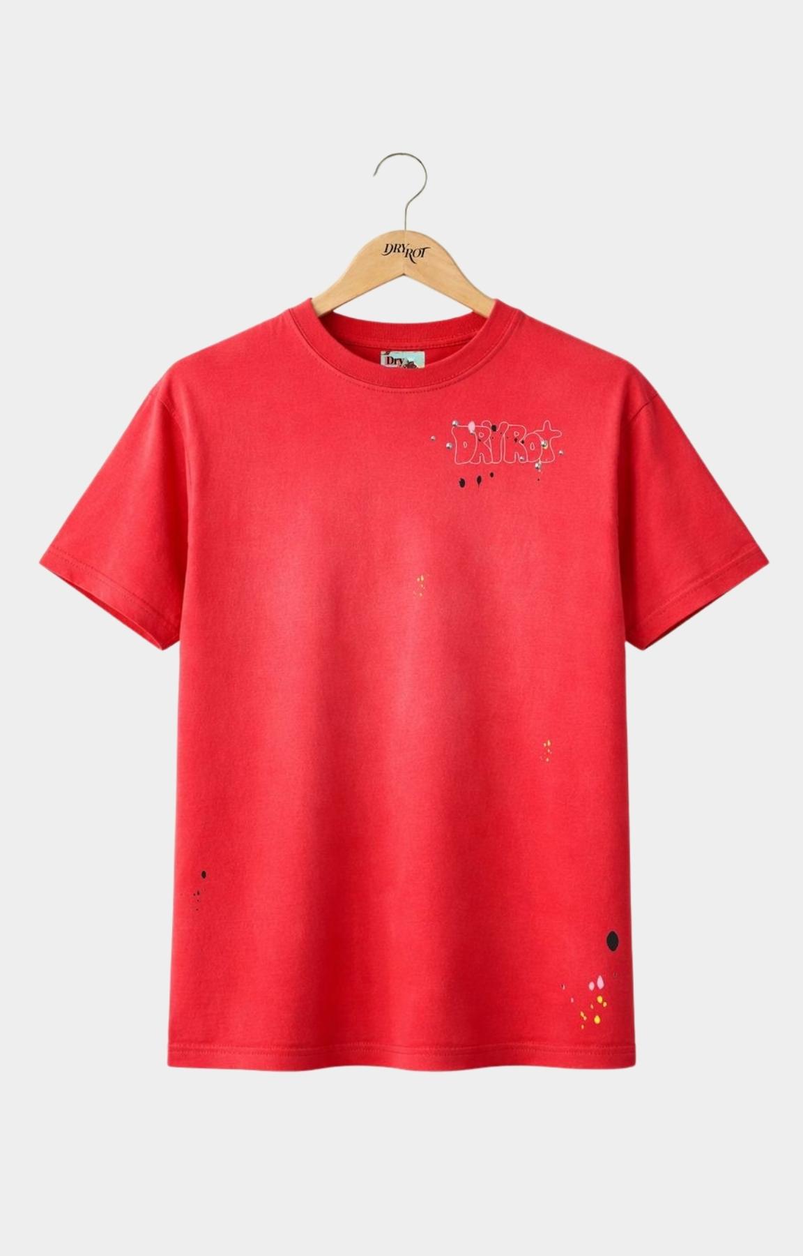 DRY ROT Dirty Silo Red graphic t-shirt front view with chest branding, short-sleeves, with a distressed, faded texture. The shirt features a small graphic on the left chest with the word 'UNICOR' and small colorful splatter details.
