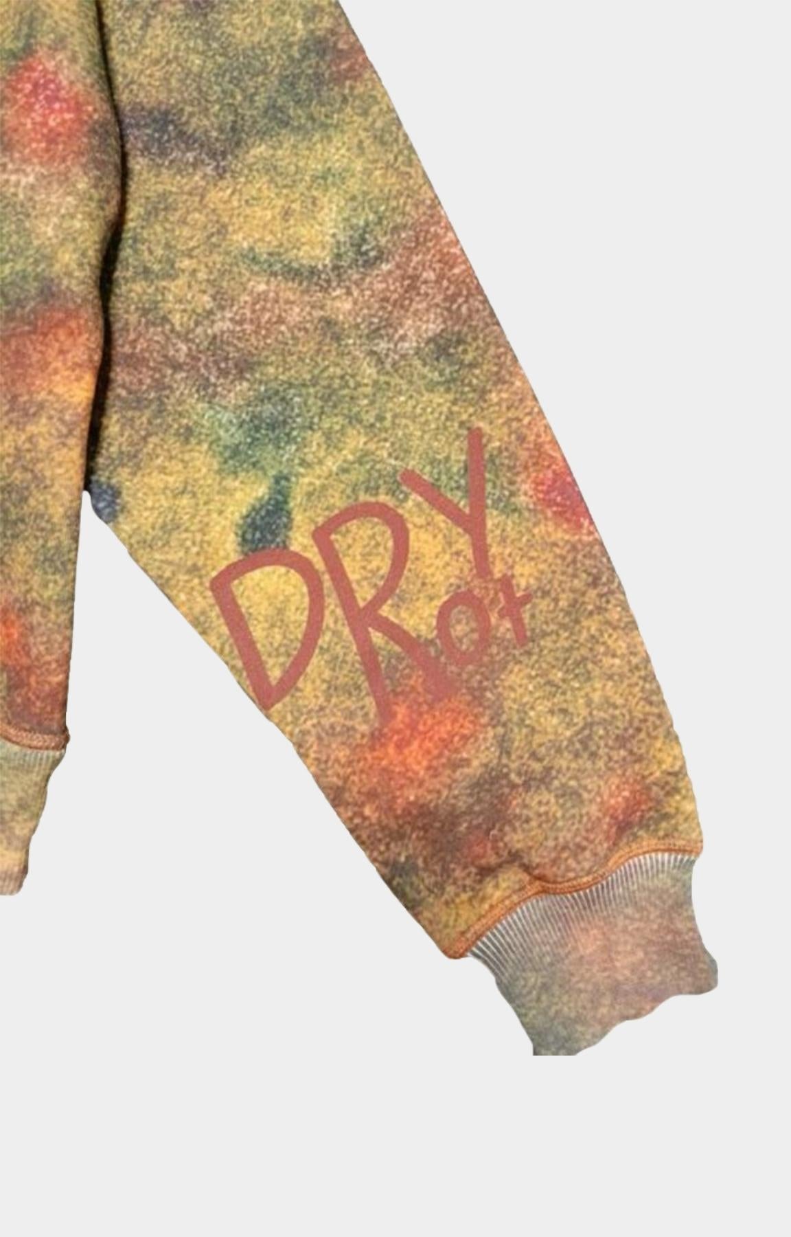 Close-up of a Dry Rot Acid Dust Zip Up Hoodie / sweatshirt sleeve with a mottled yellow, orange, and green tie-dye pattern, featuring the text 'DRY of' printed in red on the front.