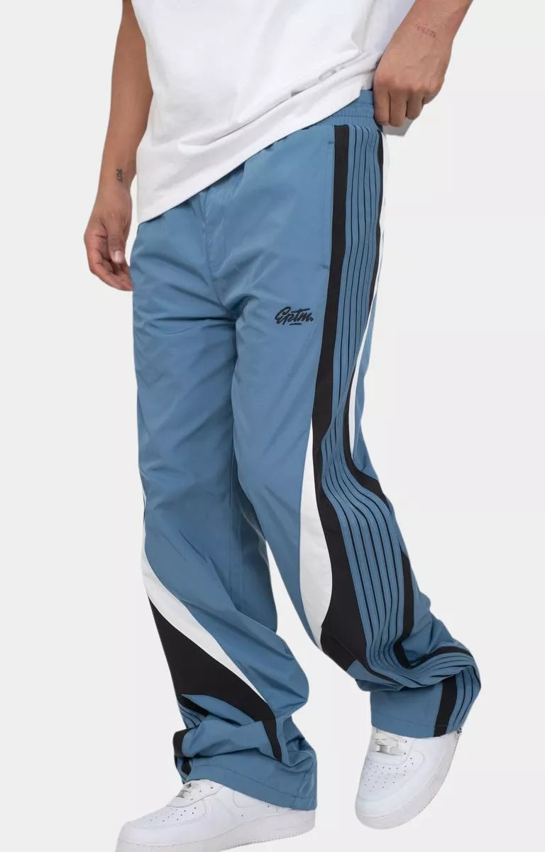 Side profile of denim blue EPTM relaxed fit pants.