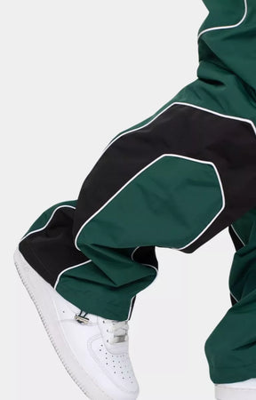 Designer EPTM track pants in hunter green relaxed fit silhouette
