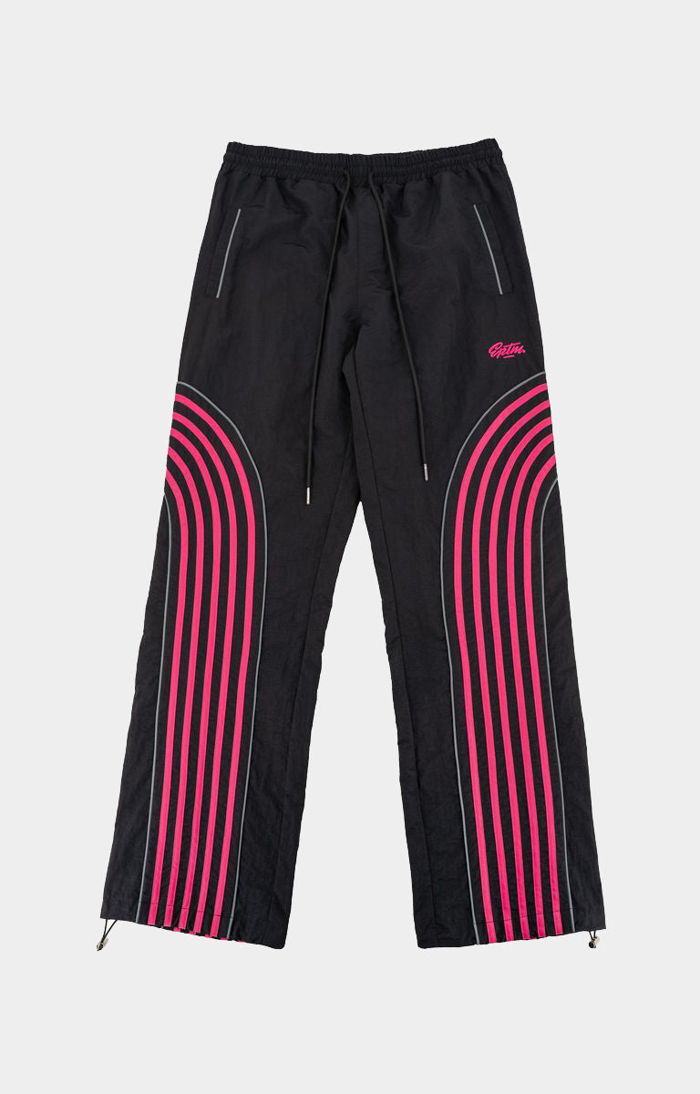 Shop EPTM Flasher Pants in Black, featuring bold pink pop-color tape, signature 3M reflective accents and a 100% polyester construction. Designed with an elastic drawstring waistband, front welt pockets, a back pocket and adjustable bottom toggles for versatile streetwear styling.