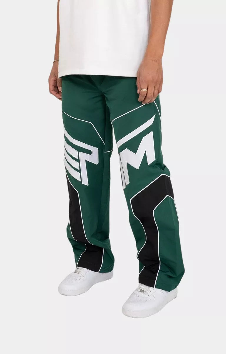 Side profile of EPTM Hunter Green Rogue streetwear pants with contrast piping