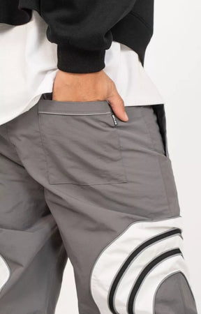 Back welt pocket detail on grey nylon ripstop pants