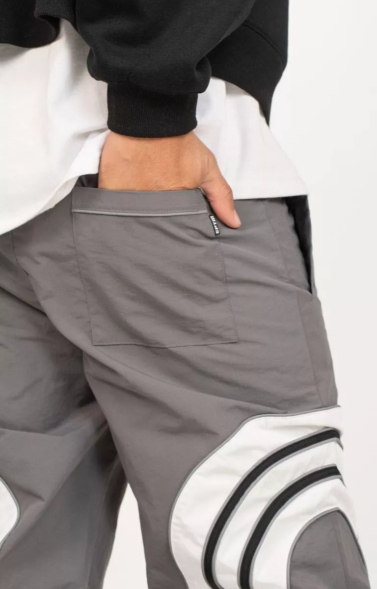 Back welt pocket detail on grey nylon ripstop pants