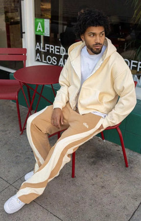Side view of model wearing loose fit EPTM sweatpants.