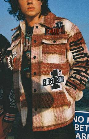 Close-up of patches and chain stitching on First Row Caution Not So Quiet Shacket.