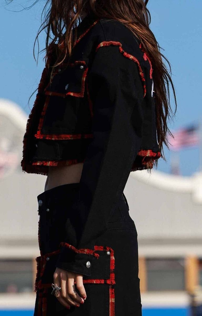 Side view of First Row Denim Plaid Edge Point Crop Jacket with frayed hem.