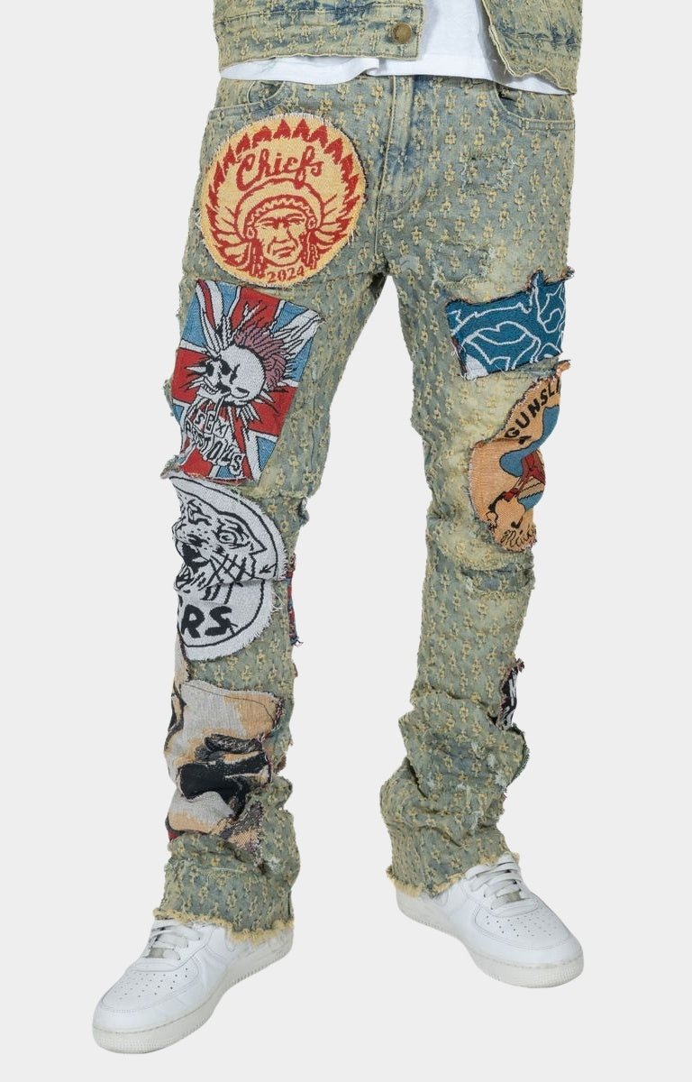 Close-up of applique tapestry artwork patches on Frost denim jeans.