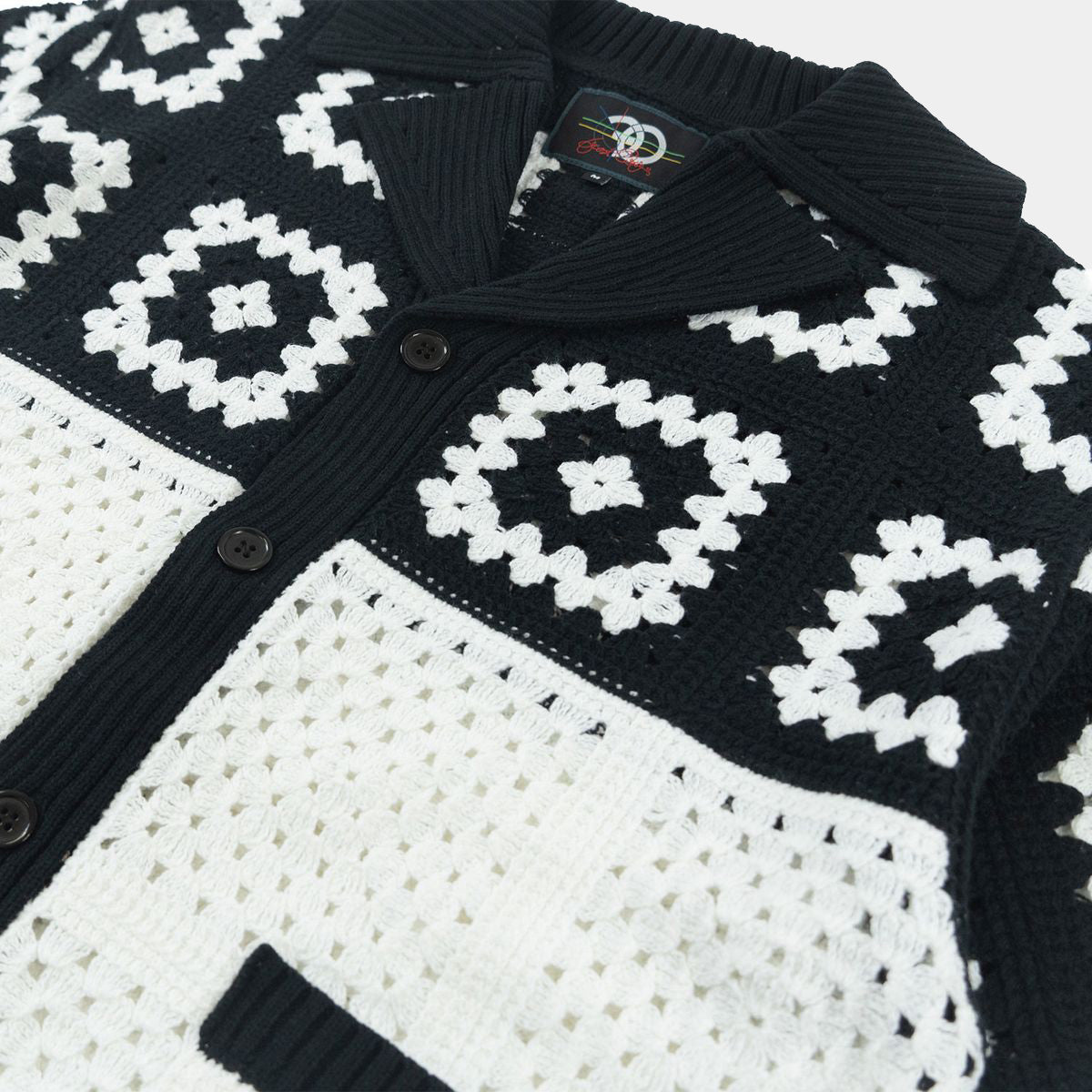 Close-up of Black White crochet knit detailing on Frost shirt.