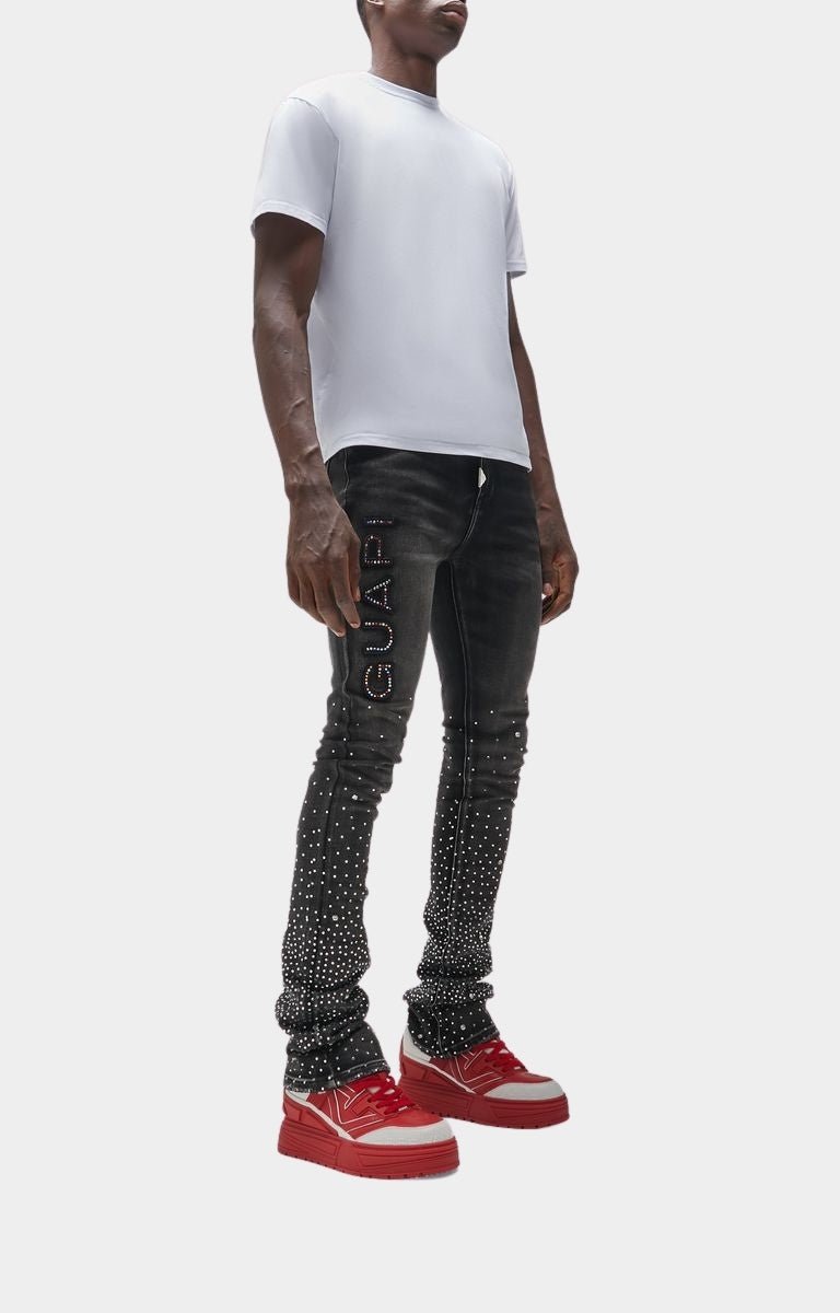 Lifestyle shot of Blood Red Reign sneakers styled with streetwear.