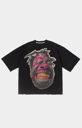Front view of GFA Manasseh Smile Oversized Black Tee with gold grill face graphic and pink God Family Art lettering.