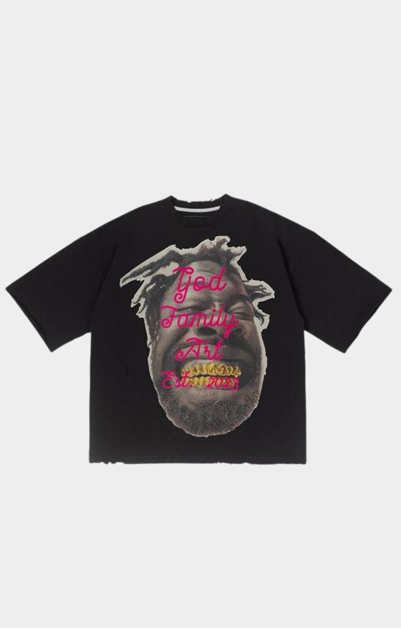 Front view of GFA Manasseh Smile Oversized Black Tee with gold grill face graphic and pink God Family Art lettering.