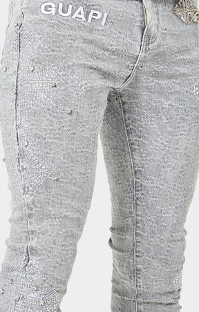Luxury streetwear denim with crystal-encrusted cross patterns.
