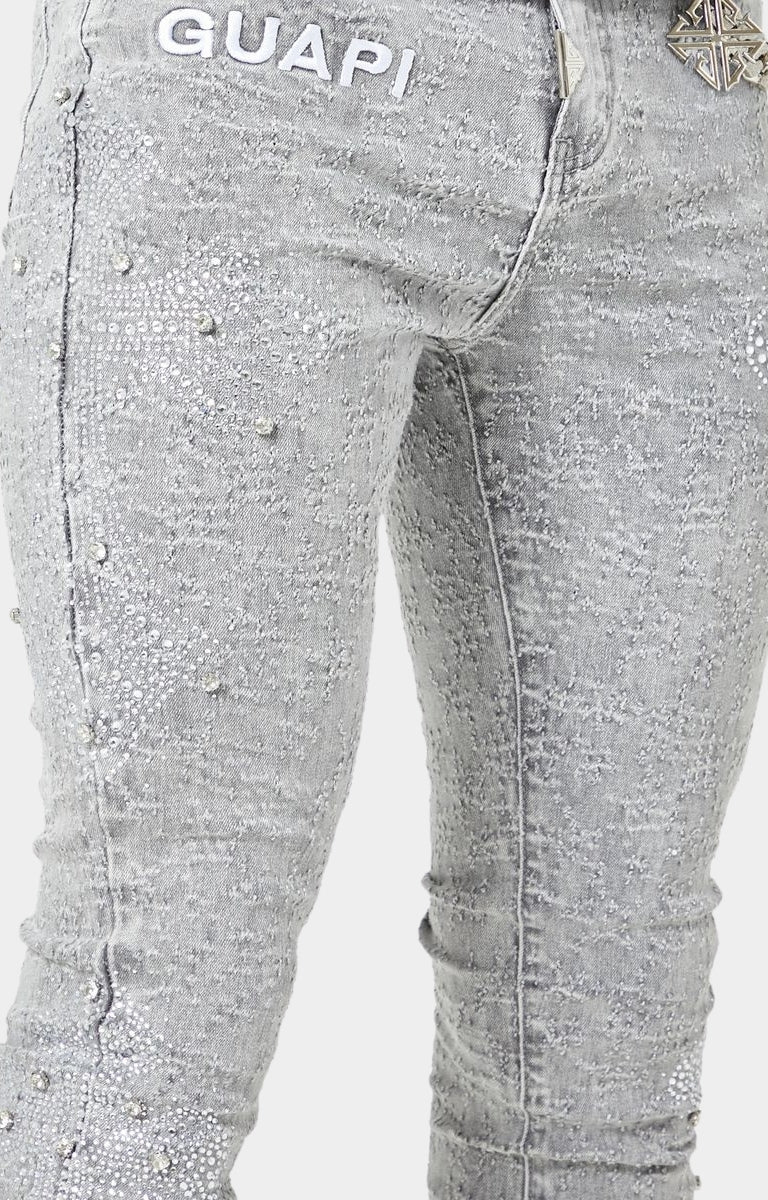 Luxury streetwear denim with crystal-encrusted cross patterns.