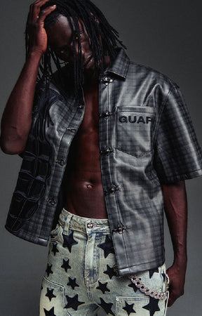 Guapi All Black Grenade Leather Shirt featuring a textured leather-look finish, tonal plaid detailing, toggle closures, embroidered branding and relaxed fit.
