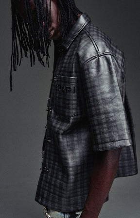Guapi All Black Grenade Leather Shirt featuring a textured leather-look finish, tonal plaid detailing, toggle closures, embroidered branding and relaxed fit.