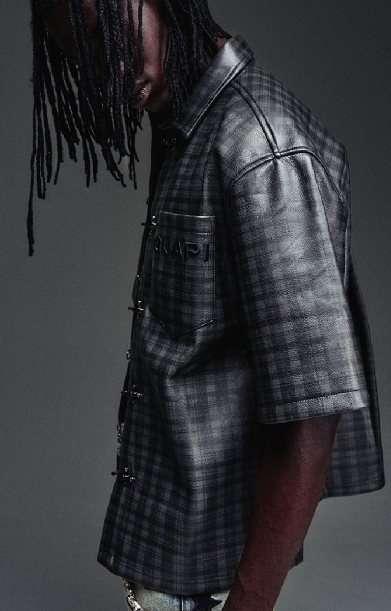 Guapi All Black Grenade Leather Shirt featuring a textured leather-look finish, tonal plaid detailing, toggle closures, embroidered branding and relaxed fit.