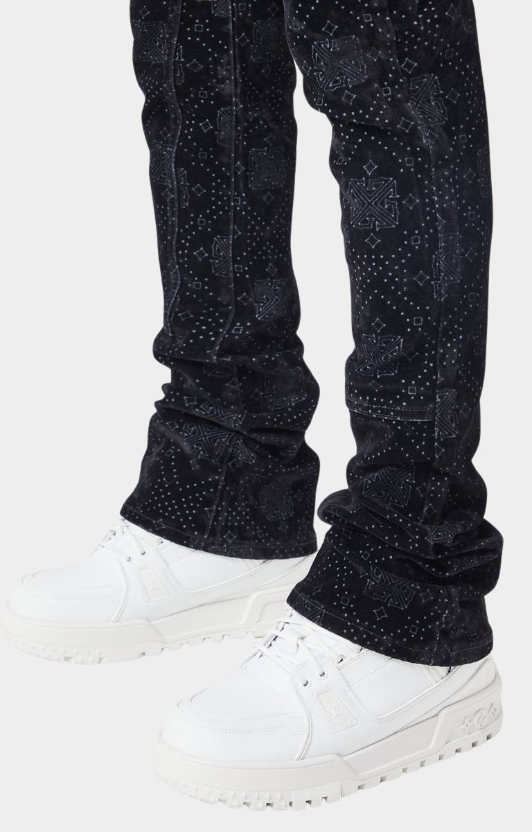 Stacked hem closeup of luxury black velour denim pants.