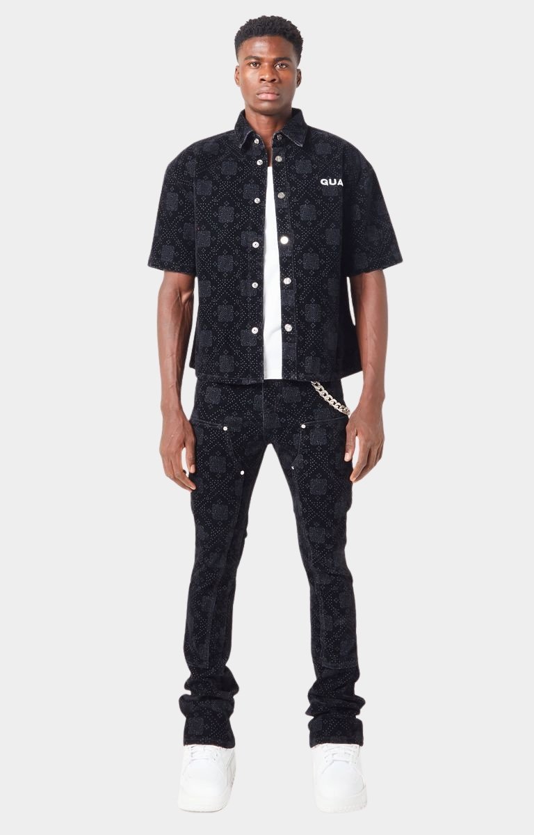 Model wearing Guapi All Black Monogram Velour Denim with sneakers and matching shirt.