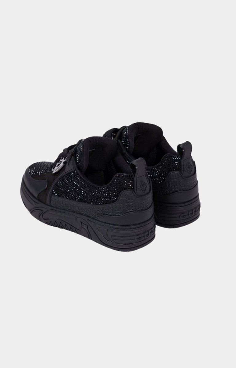 Angled view of black rhinestone designer sneaker.