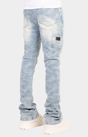 Yellow GUAPI waistband label on aqua blue denim.
