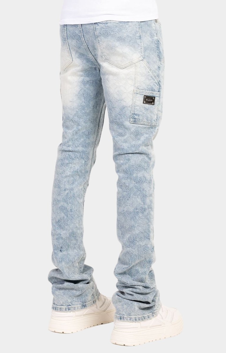 Yellow GUAPI waistband label on aqua blue denim.