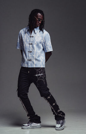Model wearing the GUAPI Aqua Blue Glock 17 Shirt with a white undershirt and denim.