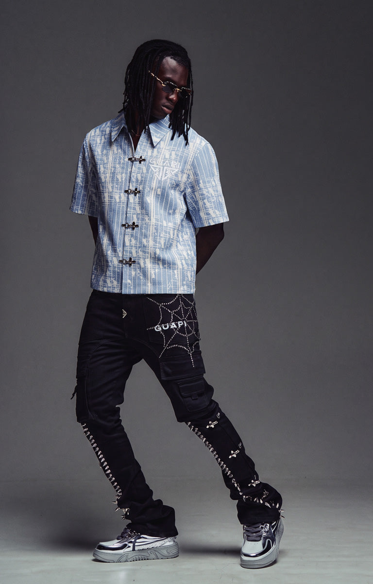 Model wearing the GUAPI Aqua Blue Glock 17 Shirt with a white undershirt and denim.