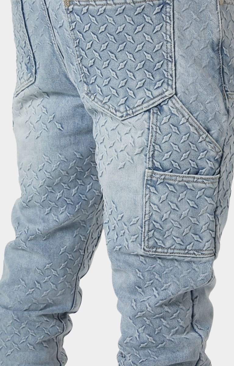 Raised steel plate embossed texture on Guapi denim.