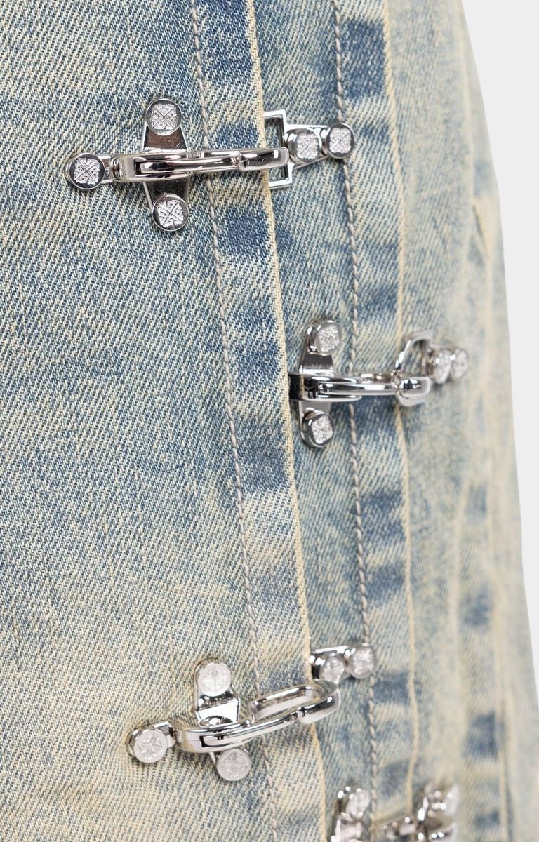 Side profile showing industrial clasp system on GUAPI denim shorts.