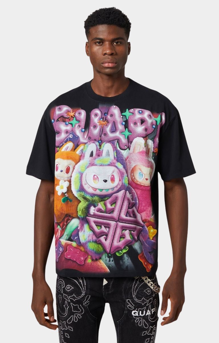 Front view of Guapi Black Candy Riot Tee V1 with candy creature graphics