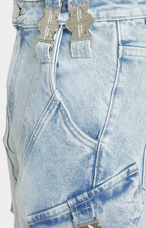 Chrome GUAPI emblem buckle detail on cargo denim.