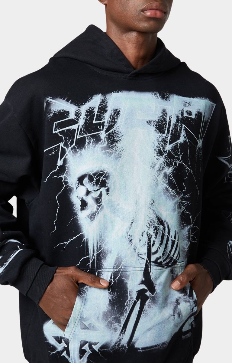 Model wearing oversized Guapi Black Revived Hoodie streetwear style