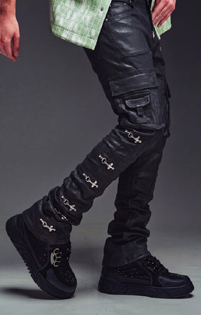 GUAPI Obsidian Black Waxed Cargo Denim crafted from heavyweight black denim with a matte wax finish, multi-panel construction, cargo pockets, silver cross-lock hardware, reinforced stitching and natural ankle stacking. Straight-slim silhouette with a true-to-size fit.