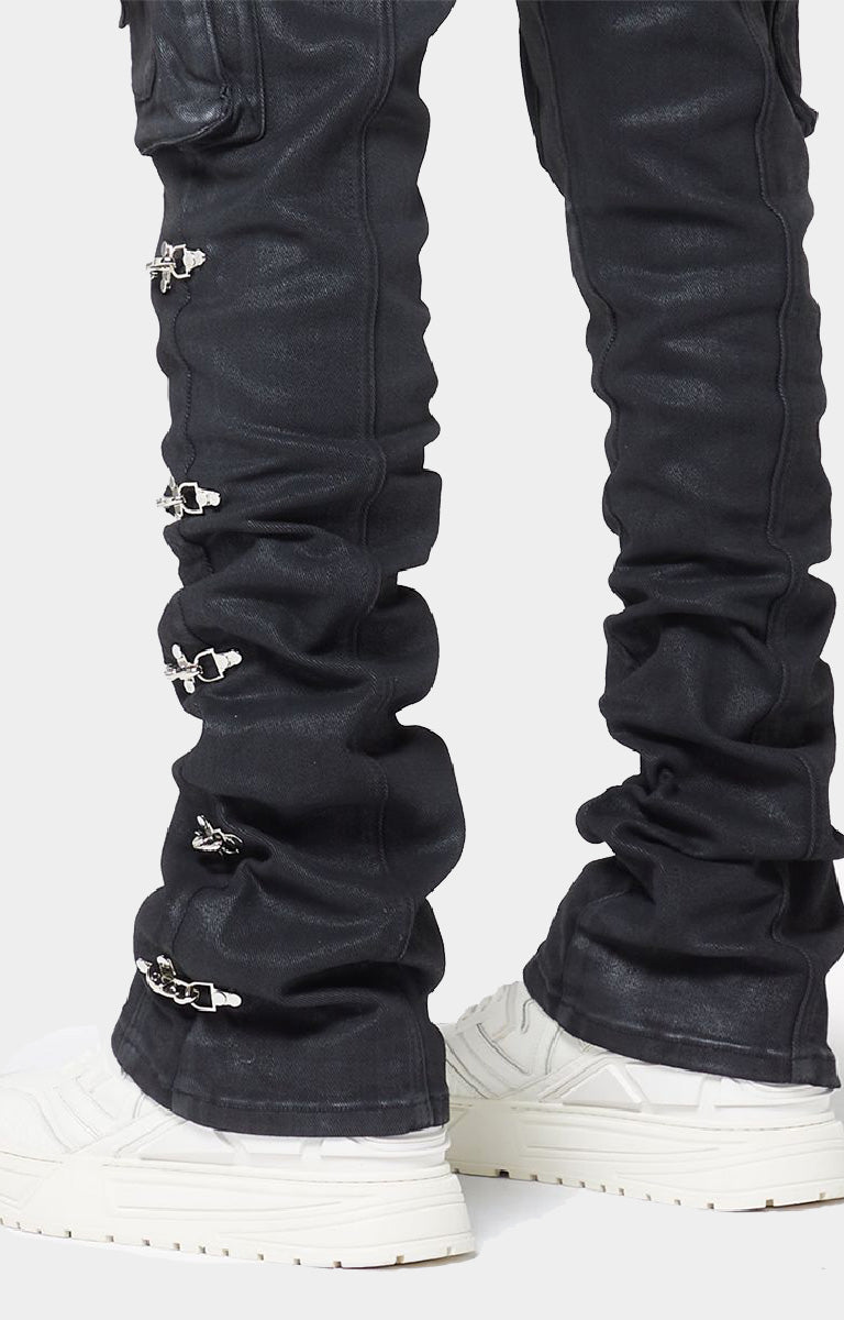 GUAPI Obsidian Black Waxed Cargo Denim crafted from heavyweight black denim with a matte wax finish, multi-panel construction, cargo pockets, silver cross-lock hardware, reinforced stitching and natural ankle stacking. Straight-slim silhouette with a true-to-size fit.