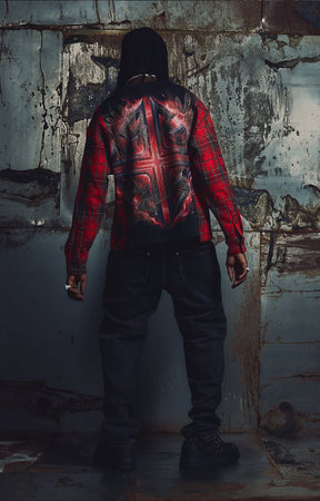 The Guapi Blood Eagle Flannel Tee in Black/Red combines a black graphic tee body with red and black plaid flannel sleeves for a distinctive layered look. Featuring bold eagle, skull, and flame-inspired artwork with decorative embellishments, this relaxed-fit statement top pairs with denim, cargo pants, and alternative streetwear outfits.