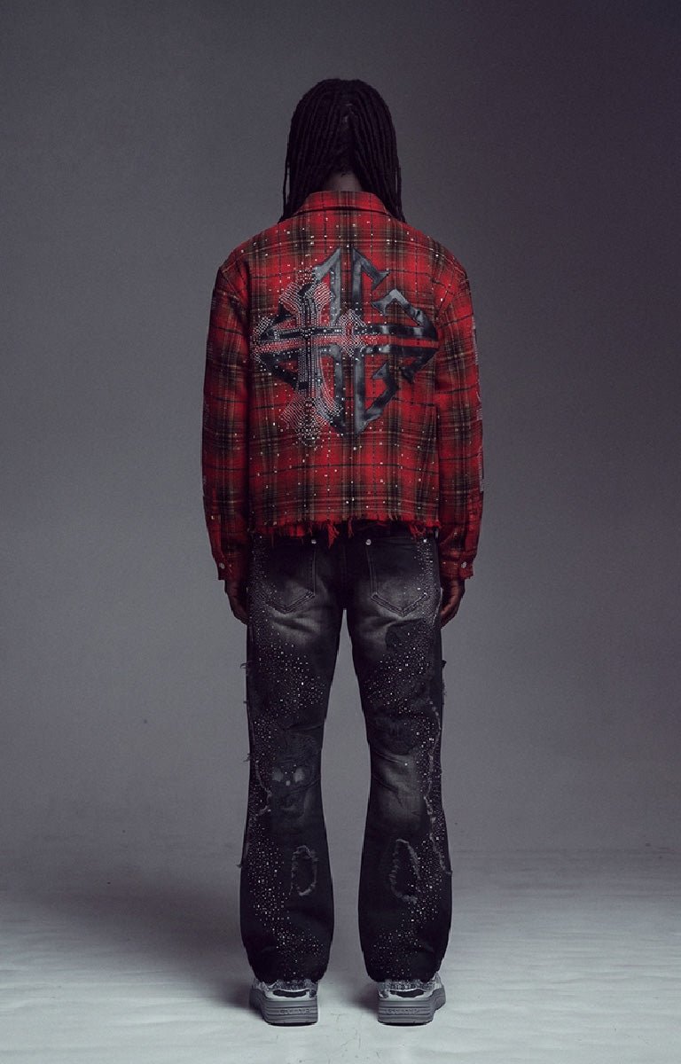 Guapi Blood Red Plaid Shirt. A red and black plaid fringed shirt with a large distressed leather cross graphic on the back, paired with dark distressed jeans and gray sneakers.