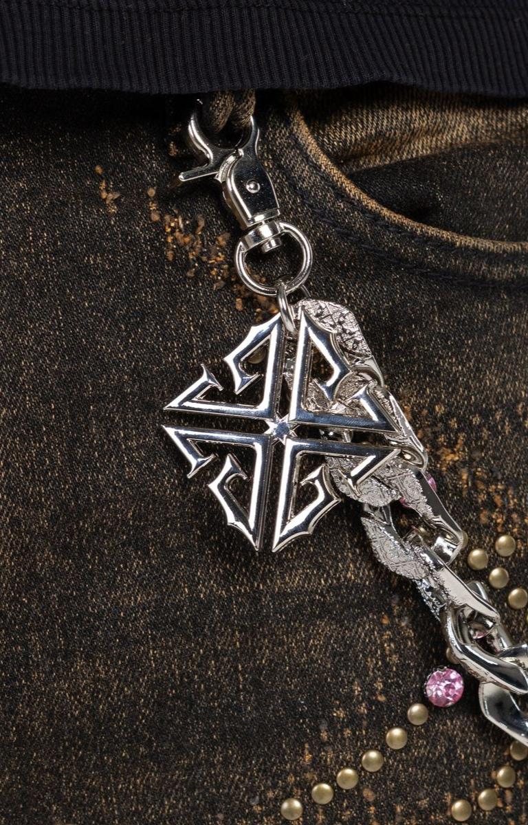 Metallic chain accessory attached to waist of Guapi Vintage brown premium denim. 