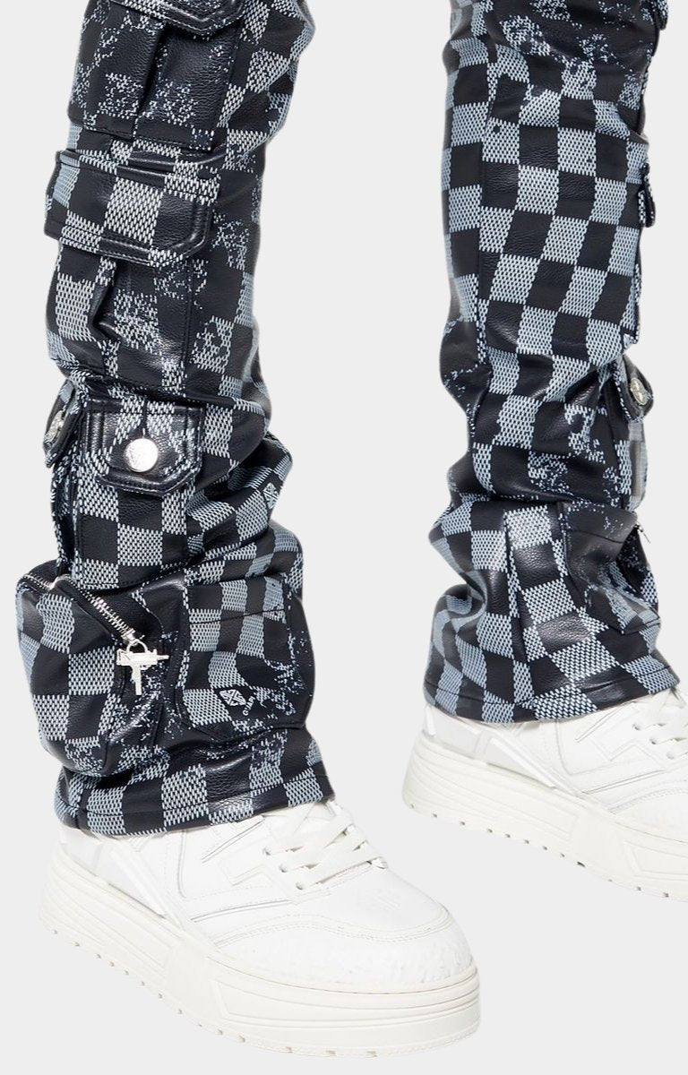 Heavy stacked leg fit of Guapi leather pants over sneakers
